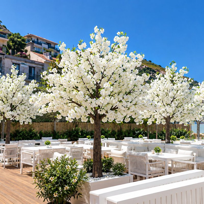 White artificial blossom trees on a restaurant terrace