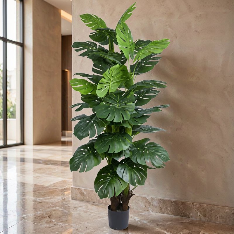 Potted artificial monstera specimen in a hotel lobby lounge