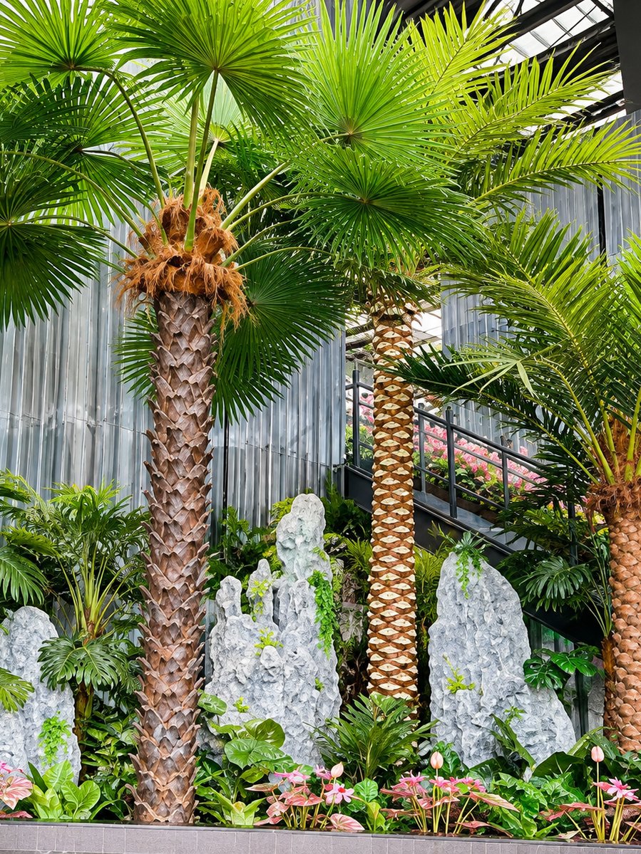 Artificial fan palm cluster with rockery planter for indoor atrium gardens